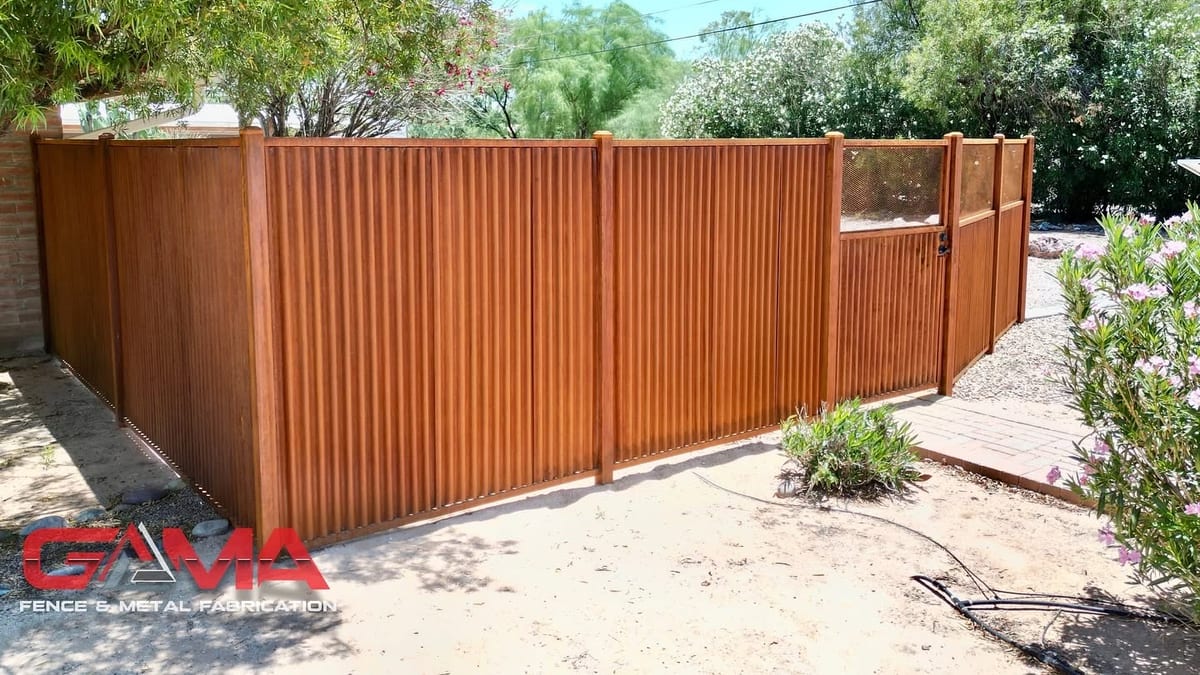 Rusted corrugated metal fence with a matching walk gate in a Tucson backyard