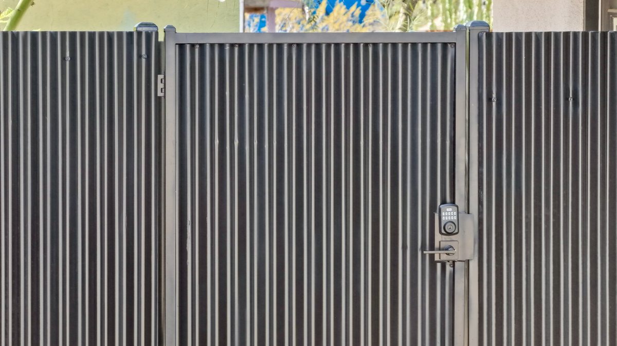 Gama Fence trusted fence experts - corrugated metal gate installation Tucson Arizona